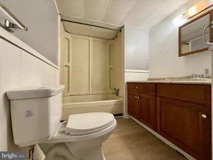 a bathroom with a toilet a sink and bathtub