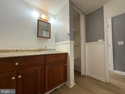 a bathroom with a granite countertop sink and mirror