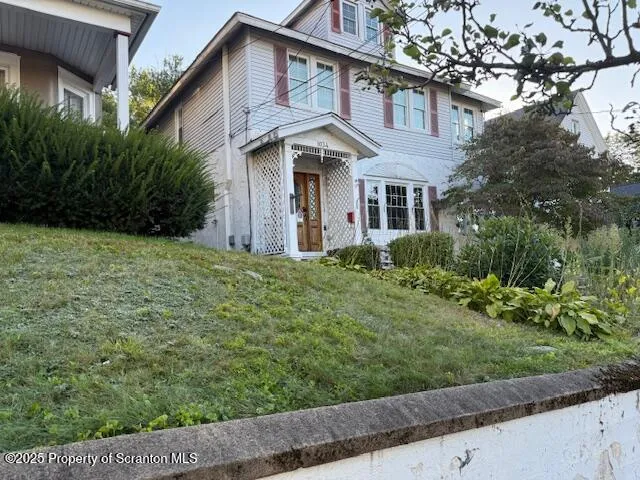 a front view of a house with a garden