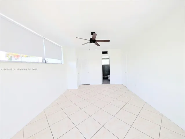 a view of a livingroom with wooden floor and a ceiling fan