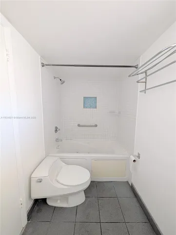 a bathroom with a toilet and a bath tub