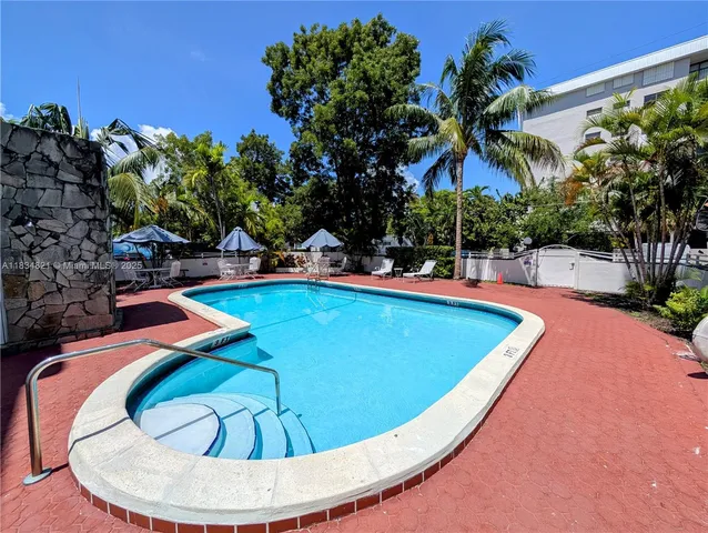 a view of a swimming pool with an outdoor seating