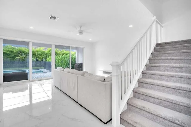 a view of entryway and hall with wooden floor