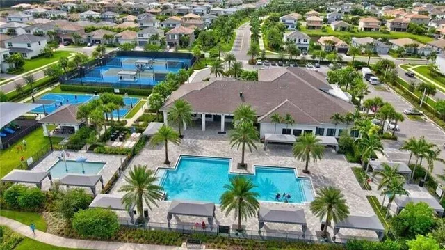 an aerial view of house with yard swimming pool and outdoor seating