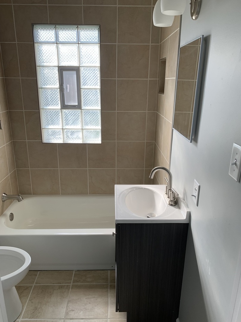 7555 West 63rd Place Summit, IL 60501 - Photo 15 of 19 a bathroom with a sink and a bathtub