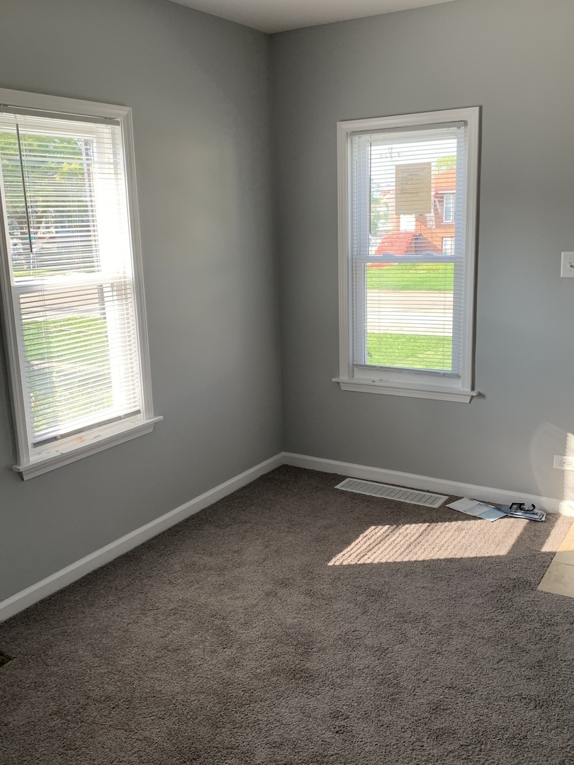 7555 West 63rd Place Summit, IL 60501 - Photo 6 of 19 an empty room with a window