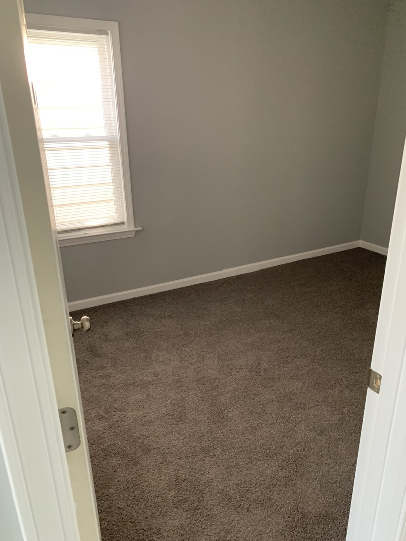 7555 West 63rd Place Summit, IL 60501 - Photo 7 of 19 an empty room with a window