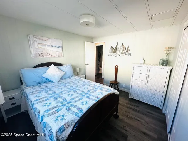 a bedroom with a bed and a dresser