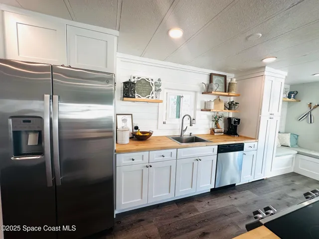 a kitchen with stainless steel appliances a refrigerator and cabinets