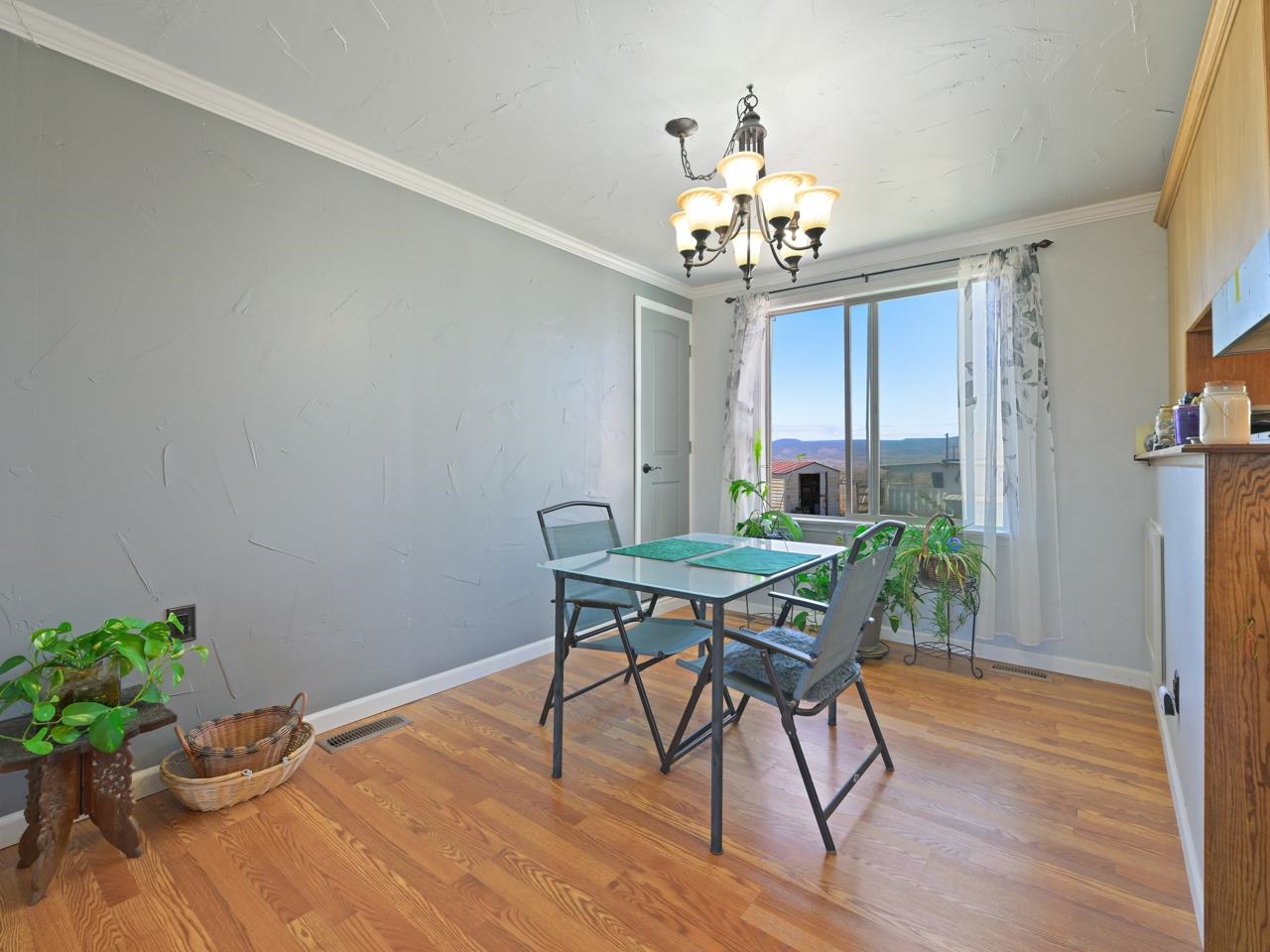 6777 Reeder Mesa Road Whitewater, CO 81527 - Photo 7 of 42 a view of a dining room with furniture and wooden floor