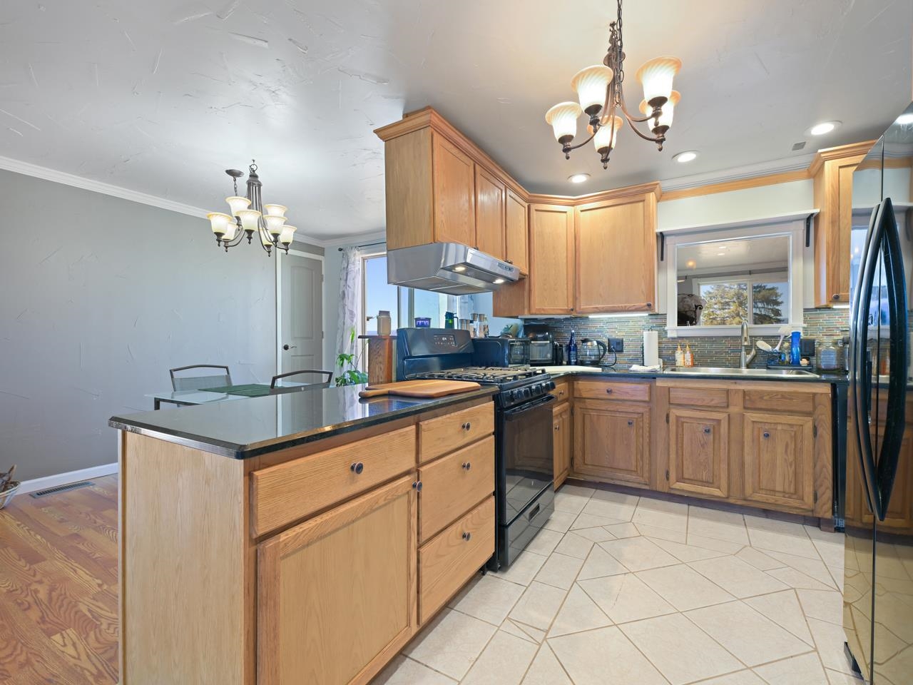 6777 Reeder Mesa Road Whitewater, CO 81527 - Photo 9 of 42 a kitchen with a cabinets counter space dining table and a chandelier