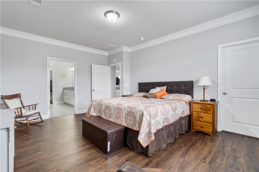 120 Rossmoor Court Anderson, SC 29621 - Photo 16 of 32 This spacious bedroom offers ample comfort and direct access to a well-appointed bathroom.