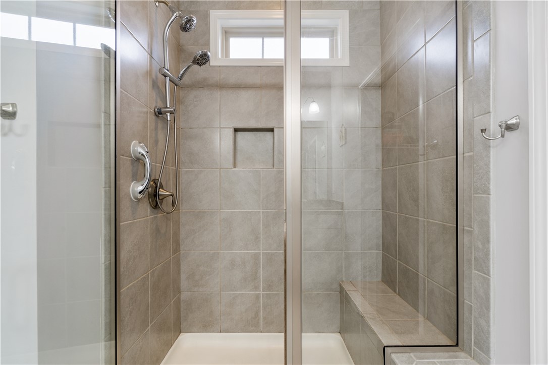 120 Rossmoor Court Anderson, SC 29621 - Photo 18 of 32 This tiled shower features a built-in bench and glass enclosure, providing a relaxing bathing experience.