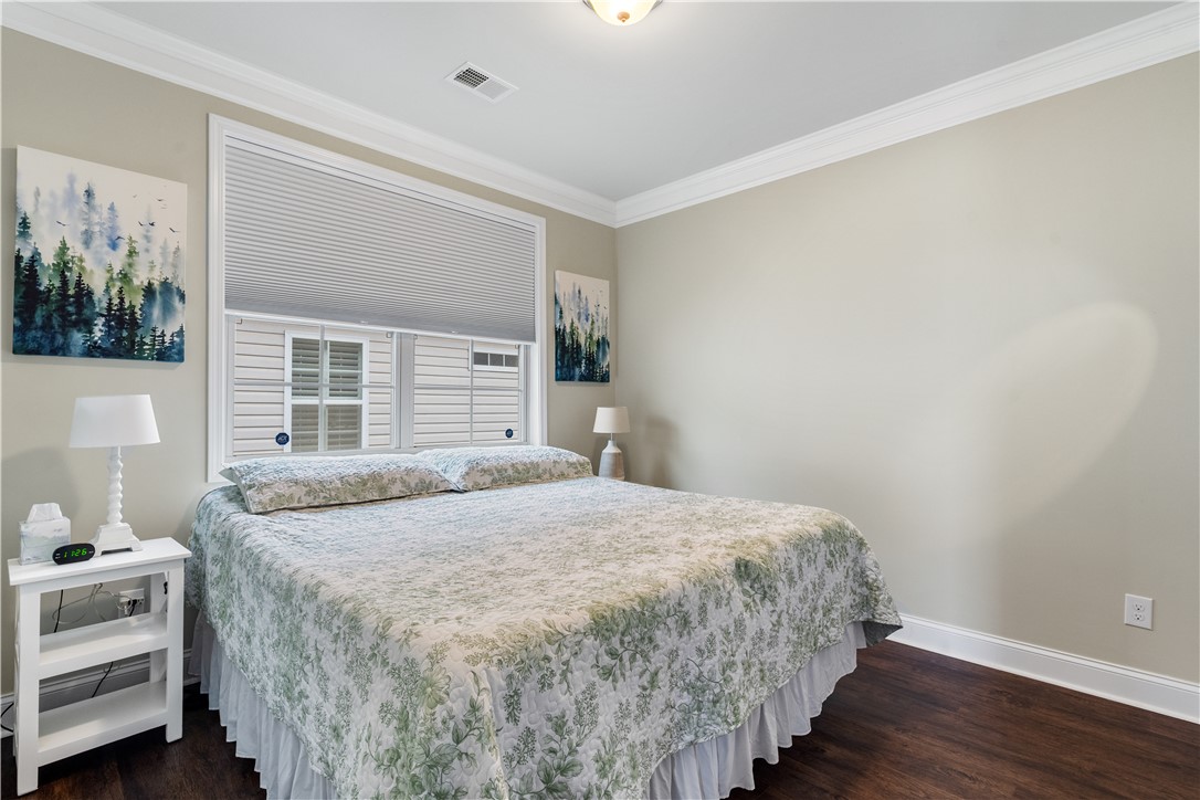 120 Rossmoor Court Anderson, SC 29621 - Photo 21 of 32 This cozy bedroom features rich wood flooring, crisp crown molding, and abundant natural light.