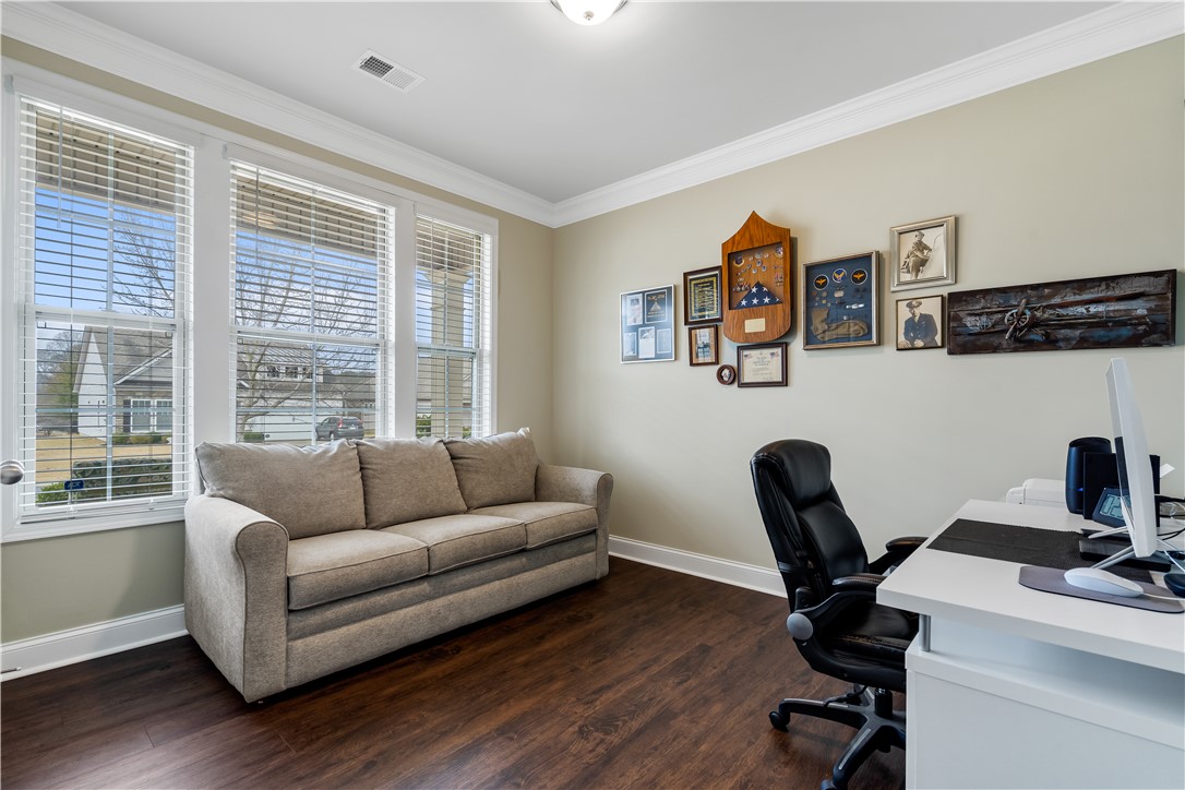 120 Rossmoor Court Anderson, SC 29621 - Photo 23 of 32 This versatile room features warm flooring and ample natural light, ideal for a home office or cozy retreat.