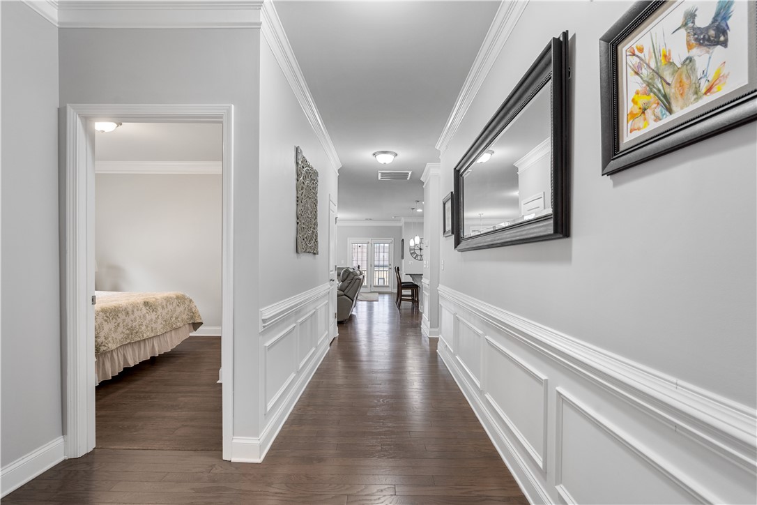 120 Rossmoor Court Anderson, SC 29621 - Photo 4 of 32 This spacious hallway features wainscoting and hardwood floors, leading to sunlit living spaces.