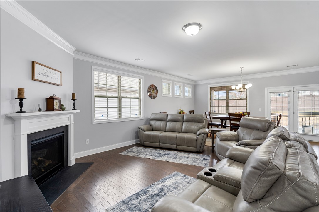 120 Rossmoor Court Anderson, SC 29621 - Photo 6 of 32 This inviting living area boasts rich hardwood floors and a cozy fireplace, perfect for gatherings.