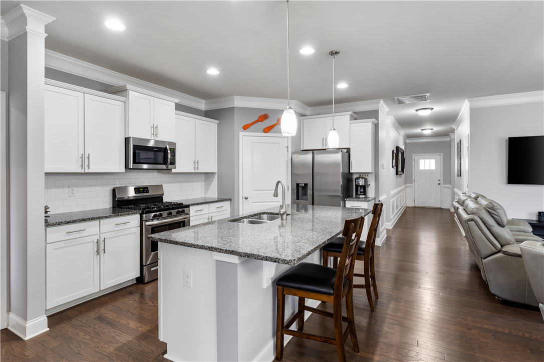 120 Rossmoor Court Anderson, SC 29621 - Photo 8 of 32 This modern kitchen features bright cabinetry, stainless steel appliances, and a spacious island.