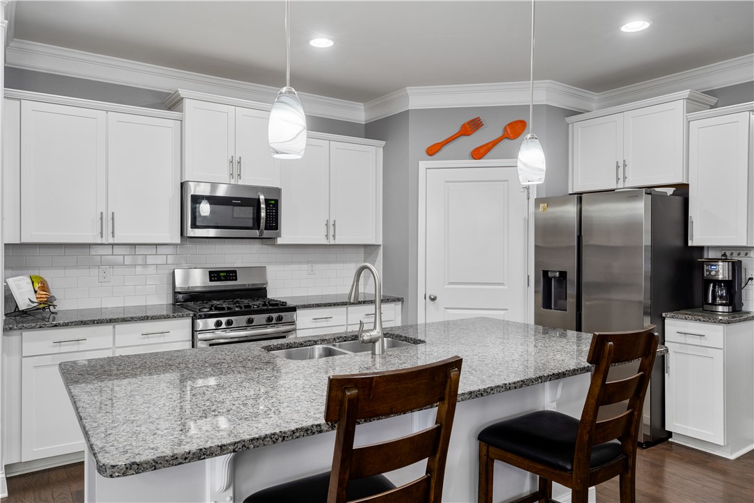 120 Rossmoor Court Anderson, SC 29621 - Photo 9 of 32 This modern kitchen features a spacious island, sleek stainless steel appliances, and ample white cabinetry.