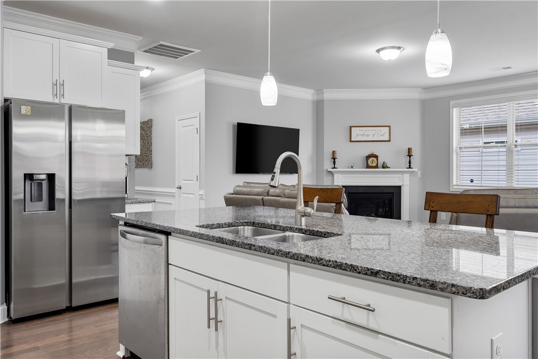 120 Rossmoor Court Anderson, SC 29621 - Photo 10 of 32 This open concept kitchen features elegant granite countertops, an inviting island, and modern stainless steel appliances.