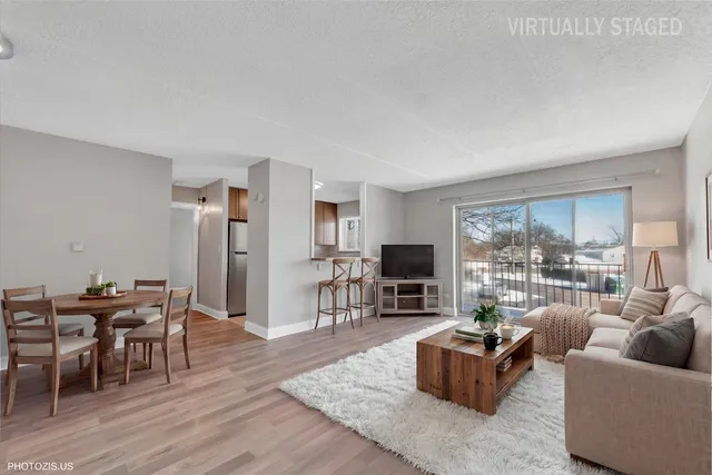 a living room with furniture a flat screen tv and a large window