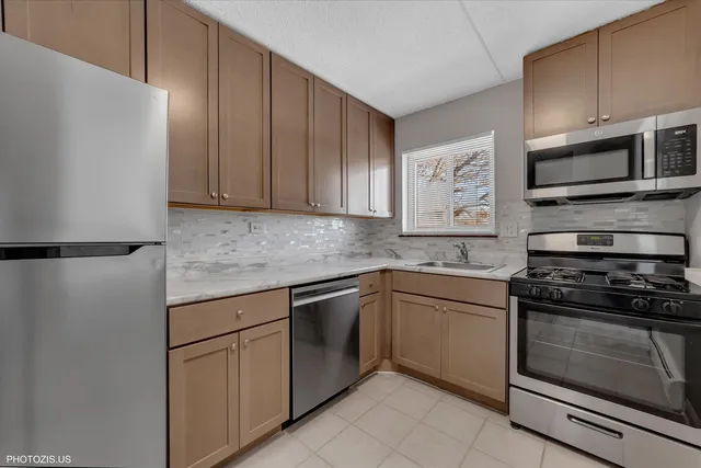 a kitchen with stainless steel appliances granite countertop a stove and a microwave