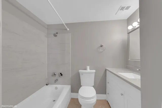 a white toilet sitting next to a bath tub