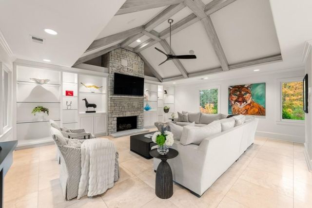 a dining room with furniture a chandelier and wooden floor