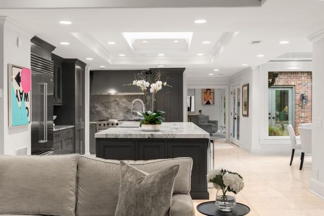 a bathroom with a granite countertop sink mirror and a toilet