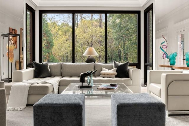 a living room with couch and a large window