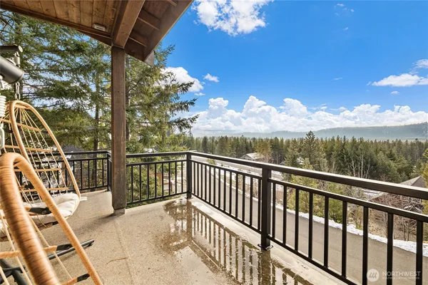 a view of a chairs and table in the balcony