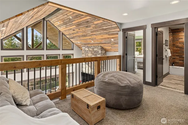a living room with furniture kitchen view and a large window