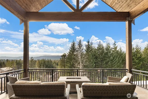 a kitchen with stainless steel appliances granite countertop a sink a stove and chairs