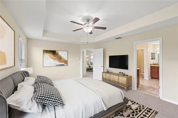 a bedroom with furniture a bed and a flat screen tv