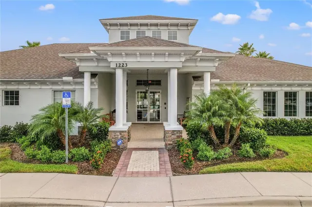 a living room with furniture a large window and a glass door