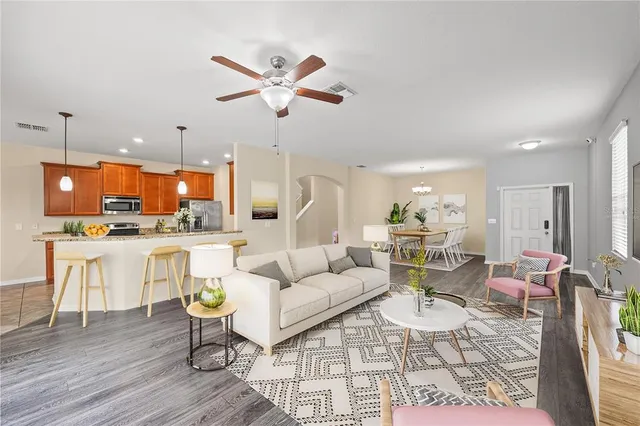 a living room with lots of furniture and kitchen view