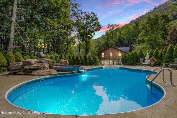 a view of a swimming pool with an outdoor space and seating area