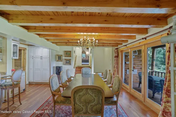 a dining room with furniture and wooden floor