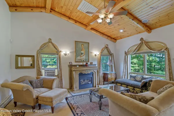 a living room with furniture a fireplace and a chandelier