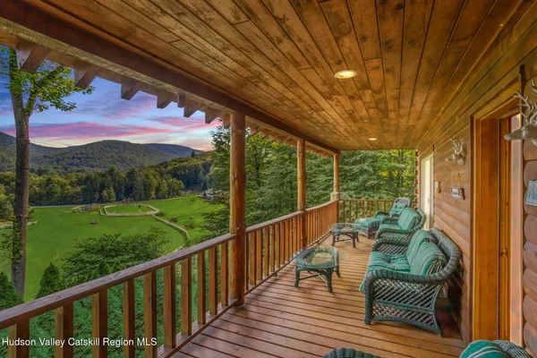 a view of a balcony with chair and wooden floor
