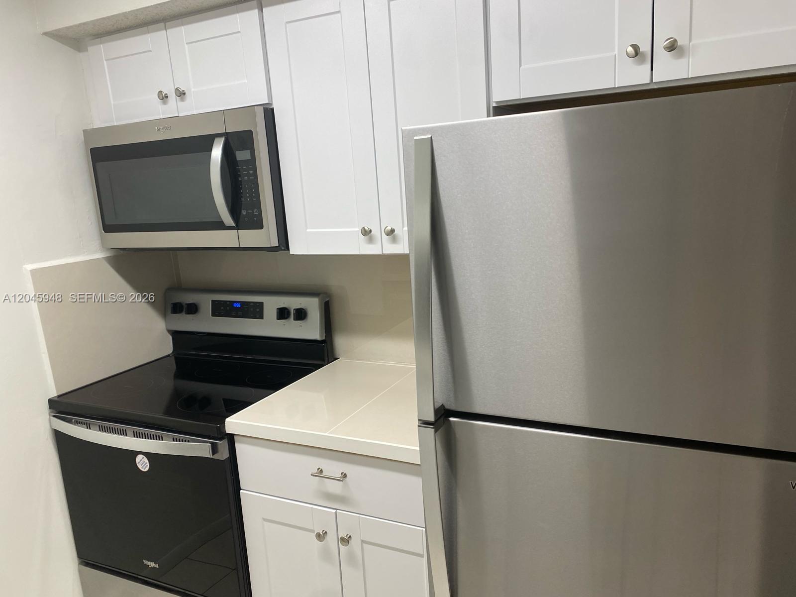 5612 Rock Island Road, Unit 167 Tamarac, FL 33319 - Photo 4 of 16 a white refrigerator freezer sitting in a kitchen