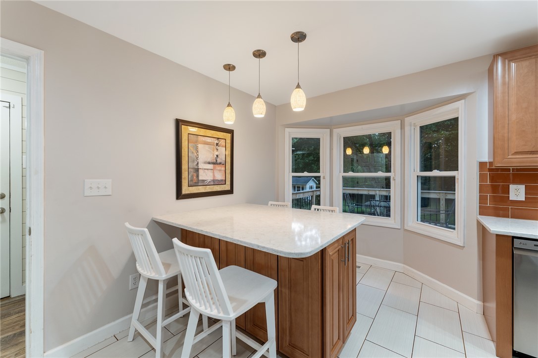 1014 East Queen Street Pendleton, SC 29670 - Photo 11 of 43 A sleek kitchen island provides a perfect breakfast bar beneath contemporary pendant lighting and large bay windows.
