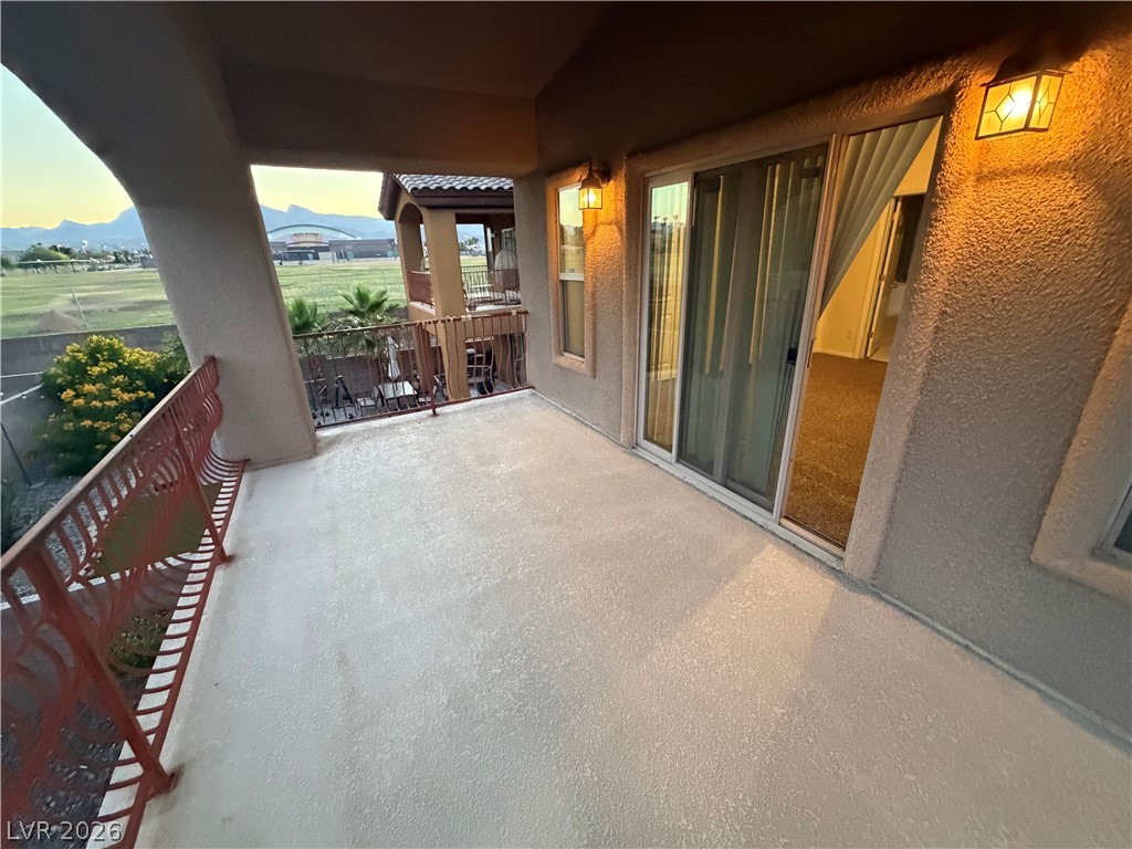 7629 Rory Court Las Vegas, NV 89129 - Photo 9 of 25 A spacious outdoor deck with scenic views of a field and mountains beckons for relaxation.