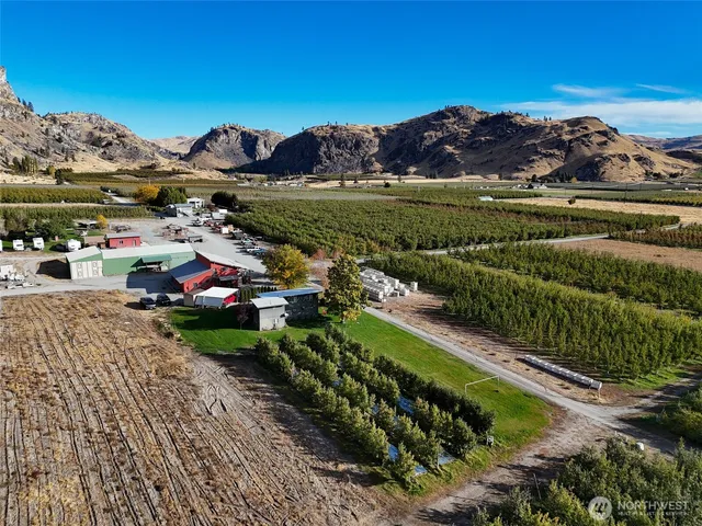 an aerial view of a house with a garden and lake view