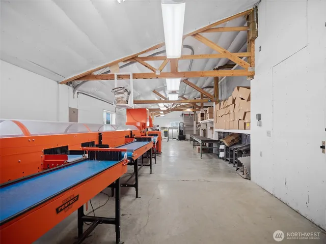 a room with lot of white furniture and window