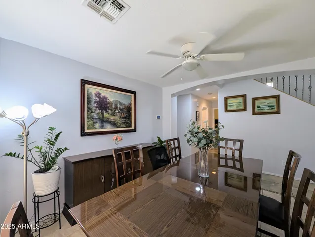 a view of a dining room with furniture and a chandelier