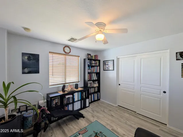 a living room with furniture a window and a flat screen tv