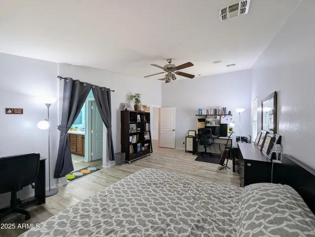 a bedroom with a bed and a chandelier