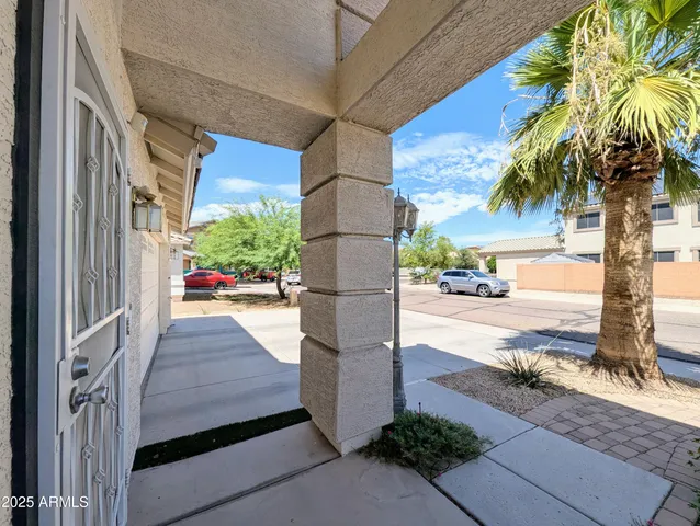 a view of a dining room with furniture and a potted plant