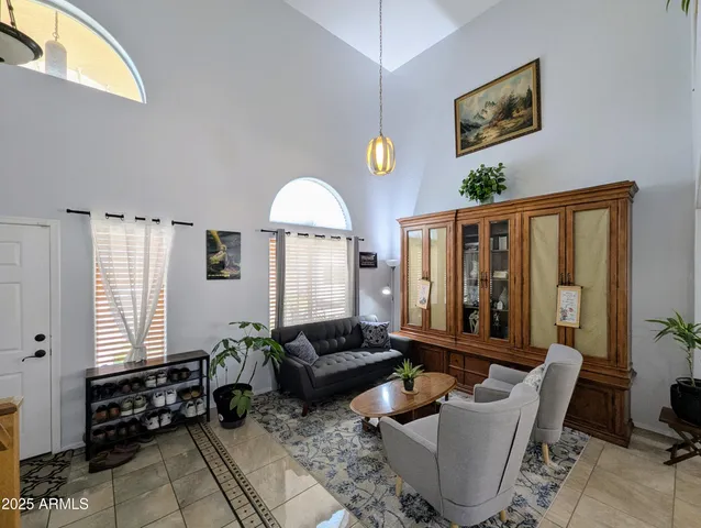 a dining room with furniture potted plants and wooden floor